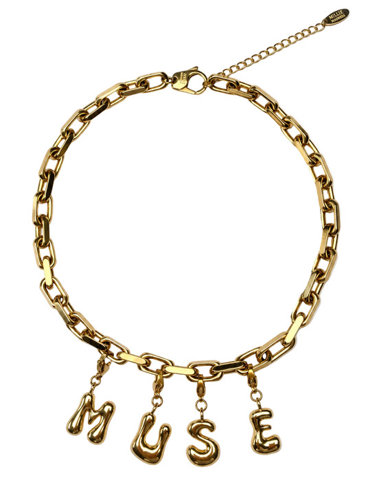 A gold-tone millie madness chain necklace with dangling letter charms spelling 'MUSE' on a plain white background.