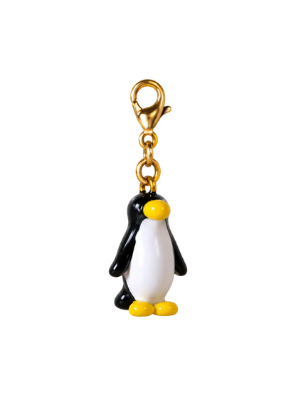 A penguin-shaped keychain charm with a gold lobster clasp, featuring a black and white body with a yellow beak and feet, isolated on a white background.