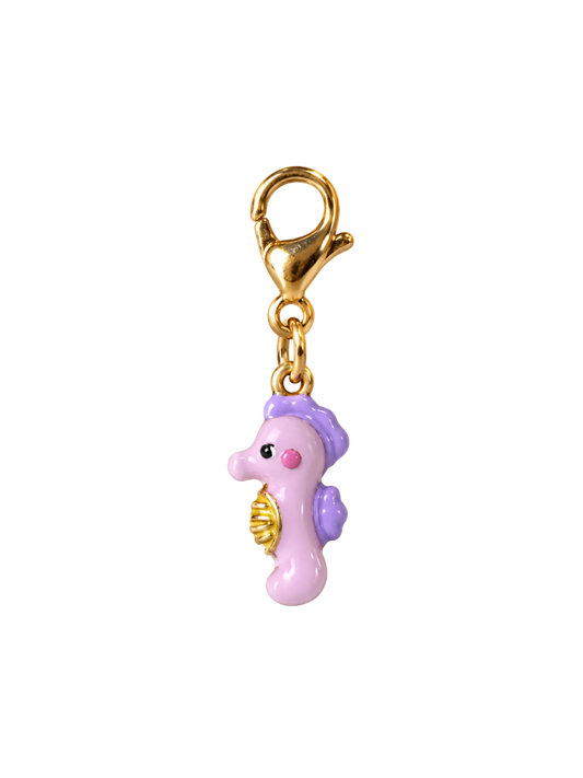 A small seahorse charm with a gold clasp, featuring a light pink body, purple details, and a gold shell accent, isolated on a white background.
