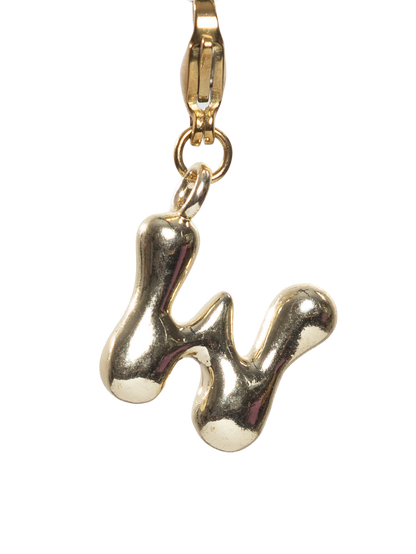Gold plated letter W charm stainless steel clasp on a white background