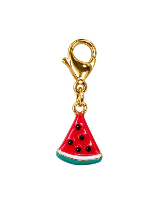 A watermelon slice charm with a gold-tone lobster clasp, featuring red and green enamel, black seeds, and a white rind detail, set against a plain white background.